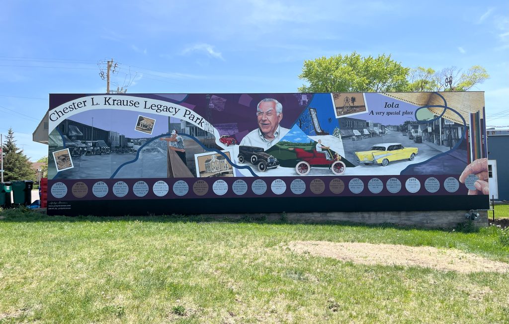 Chester L. Krause Legacy Park, Iola WI, - Golden Mural Acrylic Paint and Varnish on Exterior mural on wooden panels. 58’ x 16’. This mural was designed to highlight the history of Iola and the impact of Chester L. Krause.